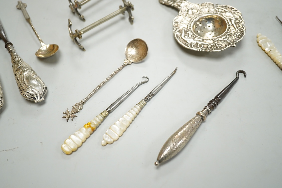 Sundry small silver and white metal items including a pair of Indian condiments, a nail buffer, two pairs of glove stretchers, a tea strainer, two spoons, a pair of plated knife rests, etc.